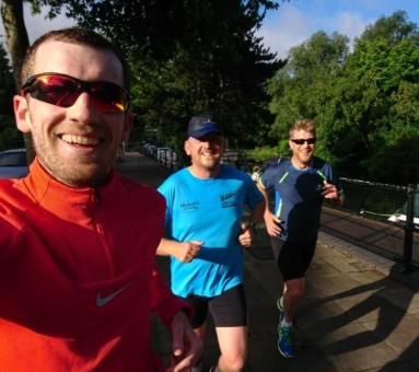 Three amigos running along riverside
